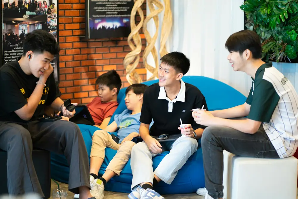 A group of young people relaxing and talking together on beanbags