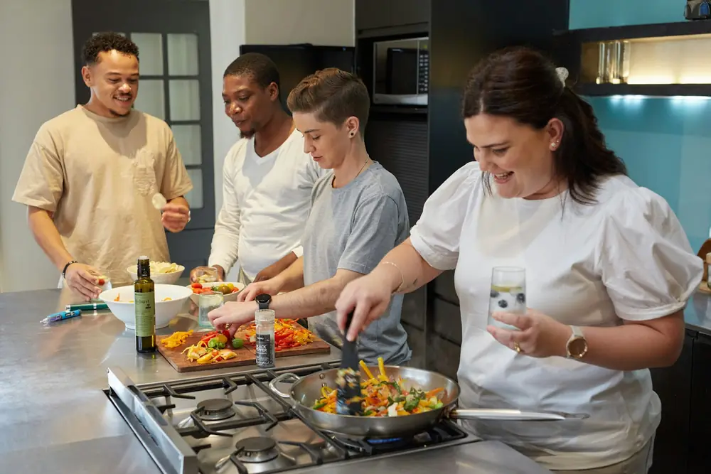 A group cooking a meal together in a kitchen